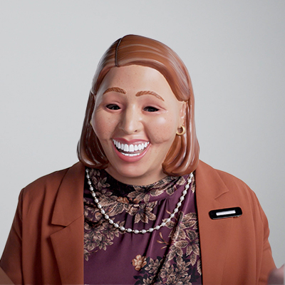 Photo of a woman in a suit wearing a mask