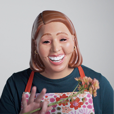 Photo of a woman with an apron on wearing a mask