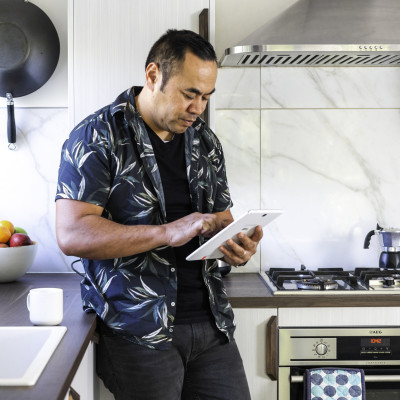 Man in the kitchen on his tablet